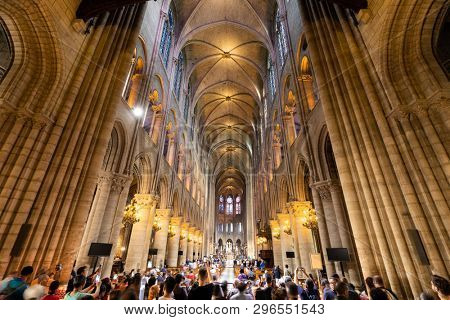 PARIS, FRANCE, SEPTEMBER 1, 2018 : Tourist crowd in the Notre Dame de Paris cathedral visiting and taking pictures