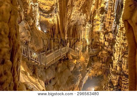 Stairs Through Dripstone Formation In Limestone Cave Of Grotte Des Demoiselles In Languedoc Southern