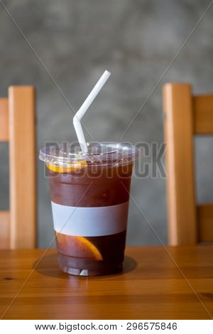 Iced Coffee Dink With Orange Slices In Glass On Wood Table
