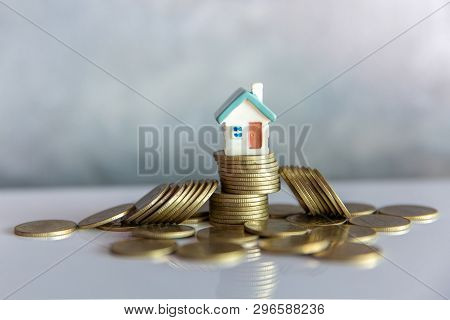 Mini House On Stack Of Coins,money And House,  Mortgage, Savings Money For Buy House And Loan To Bus