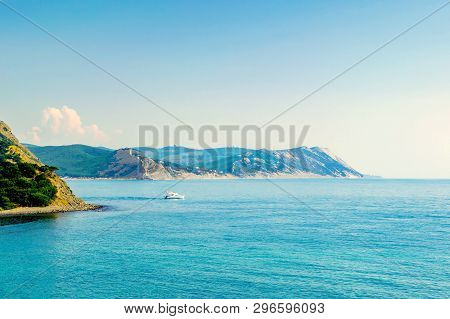 The Boat Goes Out To Sea In The Sunlight On The Background Of Beautiful Big Mountains, Luxurious Sum