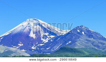 Avachinsky And Kozelsky Volcanoes In Kamchatka In The Autumn With A Snow-covered Top