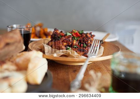 Low Angle View Of Table Served With Traditional British Sunday Roast Dinner, Featuring Roasted Chick