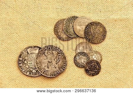 Pail Of Thalers. Old Silver Coins On Linen Background