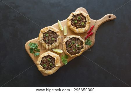 Arabian Opened Meat Pies Sfiha On Wooden Cutting Board. Top View.