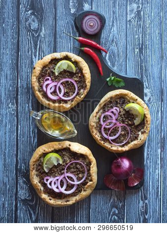 Arabian Opened Meat Pies Sfiha On Wooden Cutting Board. Top View.