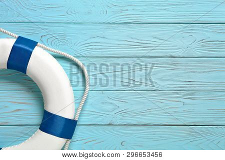 Sea Lifebuoy On Blue Wooden Background . Copy Space For Individual Text.