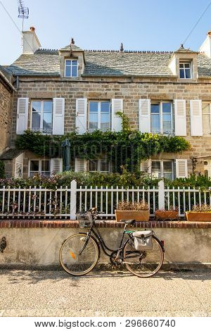Barfleur, France - August 29, 2018: Medieval Granite Houses And Bikes In Barfleur. Normandy France