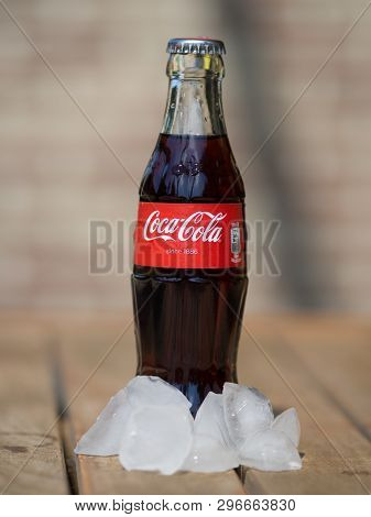 Hoeilaart, Belgium - May 17 2017: A Coca Cola Bottle Surrounded By Ice Cubes.