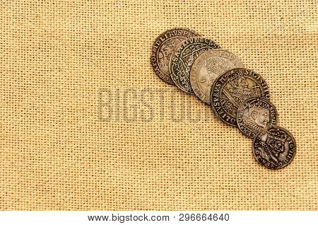 Pail Of Thalers. Old Silver Coins On Linen Background