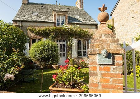 Barfleur, France - August 29, 2018: Traditional Granite House And Beautiful Courtyard In Barfleur. N