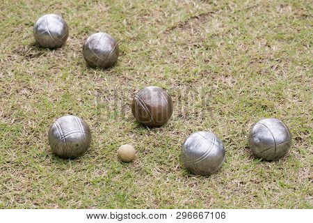 Petanque Balls Lying On The Ground With The Other Balls In The Background