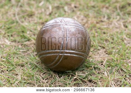 Petanque Balls Lying On The Ground With The Other Balls In The Background