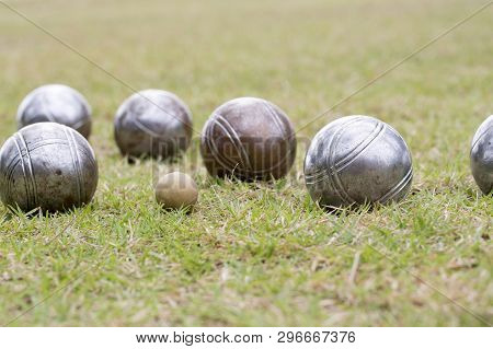 Petanque Balls Lying On The Ground With The Other Balls In The Background