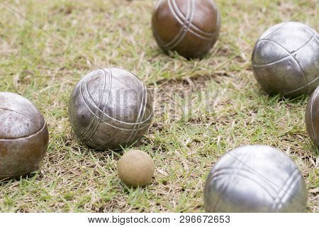 Petanque Balls Lying On The Ground With The Other Balls In The Background