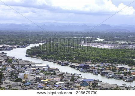 The Point Of View Of Cityscape And A Boat Parked In Tha Taphao River , Background Mountains And  Sky