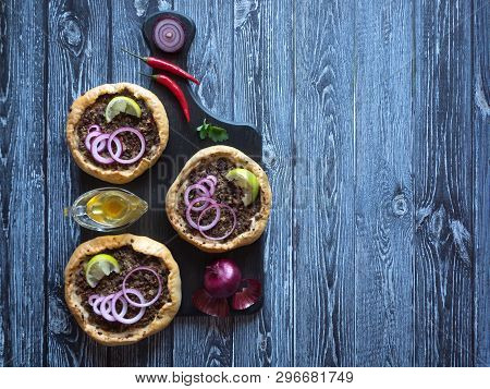 Arabian Opened Meat Pies Sfiha On Wooden Cutting Board. Top View.