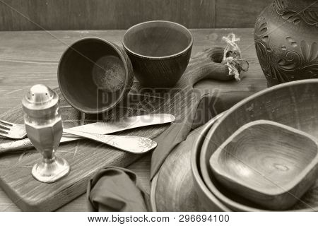 Monochrome Photo Of Rustic Pottery And Home Interior Decor. Antique Crockery