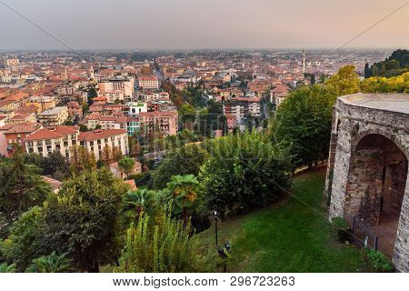 View Of Bergamo City And Old Bridge On Via Sant Alessandro Street To Upper City Cita Alta At Sunset.