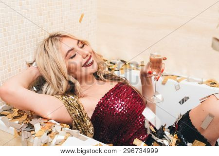 Luxe Fashion Style Girls Party. Spoilt Blonde Lady In Cocktail Mini Dress Relaxing With Champagne In