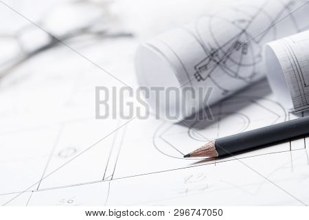 Rolls Of Drawings With Eyeglasses In The Background
