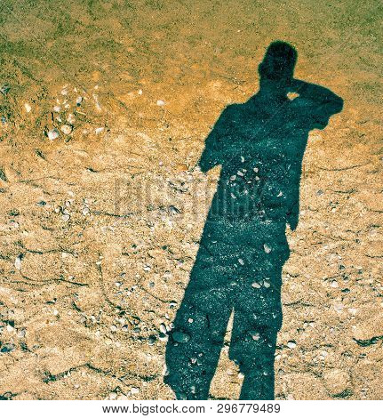 The Shadow Of A Man In The Sand, The Sun Shines In The Back, The Shadow Floats On The Squeak