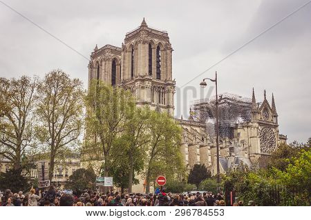 Paris, France - April 16th, 2019: Crowd Standing In Front Of The Cathedral Notre Dame De Paris After