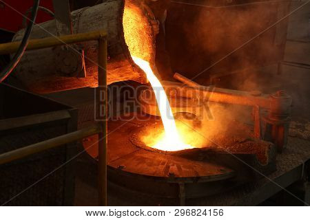 Molten Iron Pour From Ladle Into Melting Furnace ; Foundry Porcess