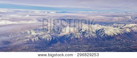 Aerial View From Airplane Of The Wasatch Front Rocky Mountain Range With Snow Capped Peaks In Winter