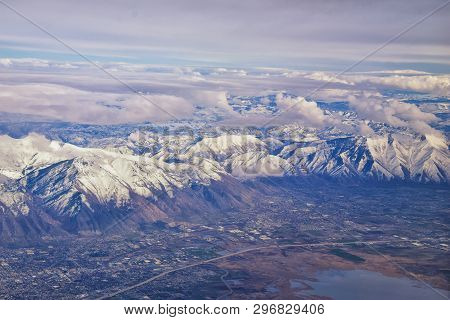 Aerial View From Airplane Of The Wasatch Front Rocky Mountain Range With Snow Capped Peaks In Winter