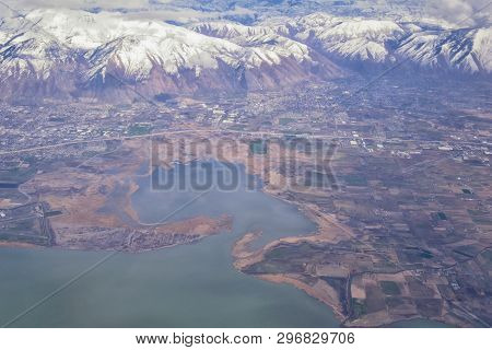 Aerial View From Airplane Of The Wasatch Front Rocky Mountain Range With Snow Capped Peaks In Winter