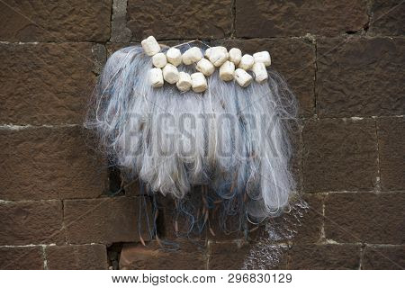 Traditional Fishing Net Hanged Against Stone Wall At Panchganga Ghat Kolhapur, Maharashtra
