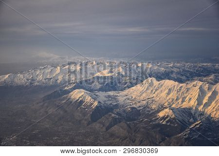 Aerial View From Airplane Of The Wasatch Front Rocky Mountain Range With Snow Capped Peaks In Winter