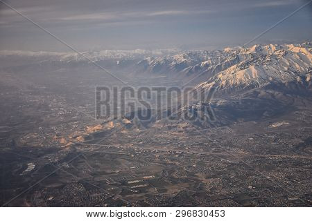 Aerial View From Airplane Of The Wasatch Front Rocky Mountain Range With Snow Capped Peaks In Winter