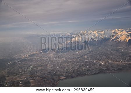 Aerial View From Airplane Of The Wasatch Front Rocky Mountain Range With Snow Capped Peaks In Winter