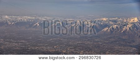 Aerial View From Airplane Of The Wasatch Front Rocky Mountain Range With Snow Capped Peaks In Winter