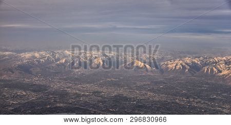 Aerial View From Airplane Of The Wasatch Front Rocky Mountain Range With Snow Capped Peaks In Winter