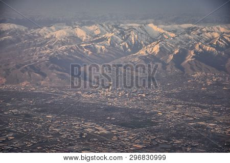 Aerial View From Airplane Of The Wasatch Front Rocky Mountain Range With Snow Capped Peaks In Winter