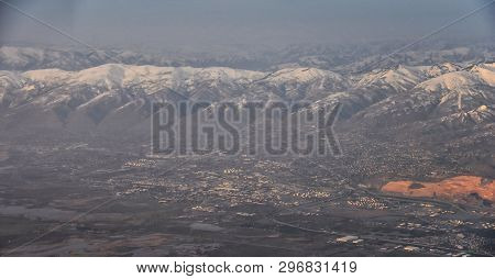 Aerial View From Airplane Of The Wasatch Front Rocky Mountain Range With Snow Capped Peaks In Winter