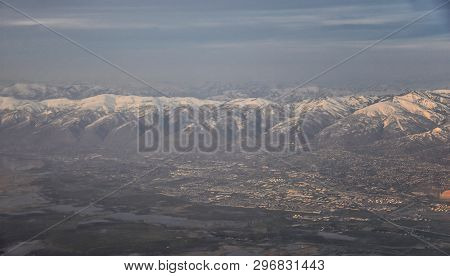Aerial View From Airplane Of The Wasatch Front Rocky Mountain Range With Snow Capped Peaks In Winter