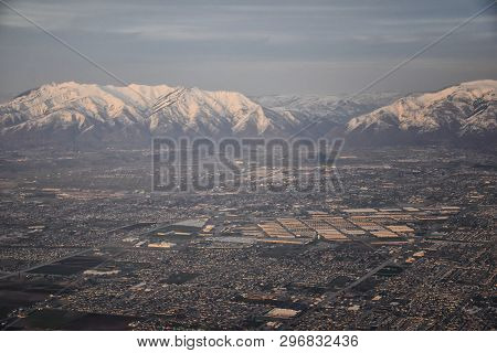 Aerial View From Airplane Of The Wasatch Front Rocky Mountain Range With Snow Capped Peaks In Winter
