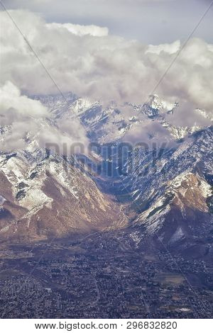 Aerial View From Airplane Of The Wasatch Front Rocky Mountain Range With Snow Capped Peaks In Winter