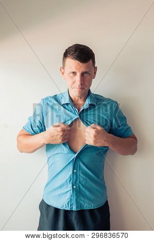 Businessman Tearing Off His Shirt And Showing Mucular Body Concept On Background