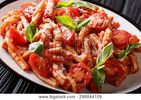 Traditional Italian Pasta Casarecce With Tomato Sauce, Parmesan Cheese And Basil Closeup On A Plate.