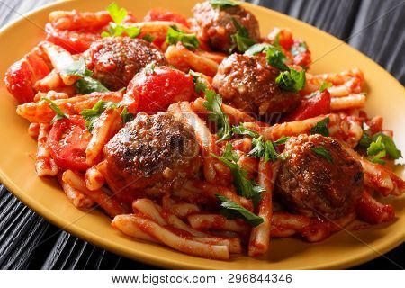Homemade Casarecce Pasta With Meatballs, Herbs And Cheese In Tomato Sauce Close-up On A Plate. Horiz