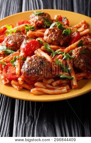 Tasty Pasta Casarecce With Meatballs In Tomato Sauce Close-up On A Plate. Vertical