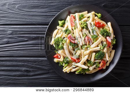 Pasta Casarecce Recipe With Vegetables, Herbs, Seasoned With Creamy Cheese Sauce Close-up On A Plate