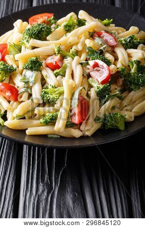 Vegetarian Pasta Casarecce With Broccoli, Garlic And Tomatoes In A Creamy Sauce Closeup On A Plate.