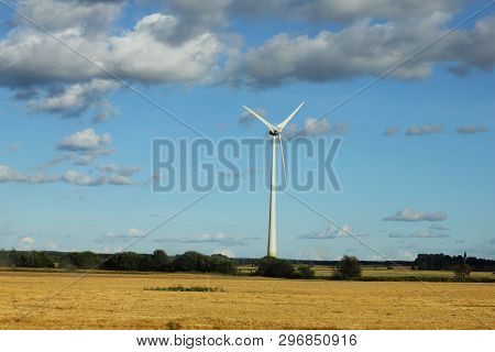 Windmill In Swedish Landscape In Summer With Cloudy Sky