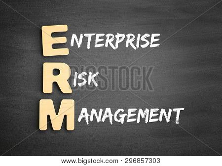 Wooden Alphabets Building The Word Erm - Enterprise Risk Management Acronym On Blackboard